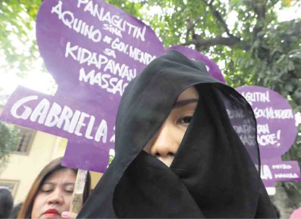 A MEMBER of militant women’s group Gabriela wears a black veil during a protest rally held in Manila for two farmers who were killed during a dispersal operation by police in Kidapawan City. MARIANNE BERMUDEZ
