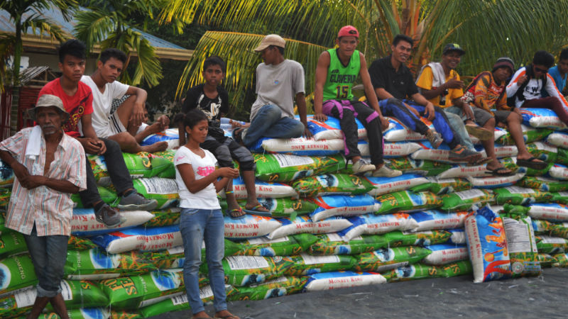 Protesters sit on the files of bags of rice inside the United Methodist Church in Kidapawan City. Action star Robin Padilla visited the protesters on Saturdat afternoon and donate at least 200 bags of commercial rice to the hungry protesters. Williamor A. Magbanua