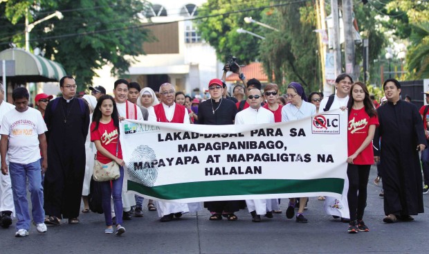  ANTICOAL  Members of religious and civil society groups march in Lucena City, Quezon province, to call on the government to stop building coal-fired power plants and using dirty sources of energy.    DELFIN T. MALLARI JR./INQUIRER SOUTHERN LUZON 