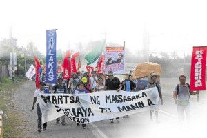 FARMERS on a protest march for genuine land reform and the return of coconut levy reach the Marharlika Highway in Quezon province after starting their 122-km journey on foot to Manila in the town of Sariaya.      CONTRIBUTED PHOTO