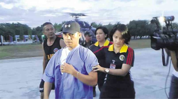 FREED Pfc. Edgardo Hilaga, who was held captive by New People’s Army rebels in North Cotabato province, is assisted by the military’s medical team following his release.   KIRBY SOLIS/CONTRIBUTOR
