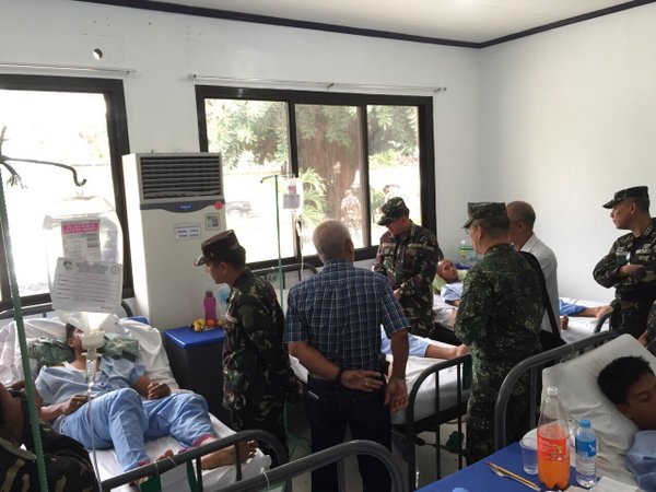 Defense chief Voltaire Gazmin and AFP chief Gen. Hernando Iriberri visit wounded troops in Basilan clashes on Sunday. PHOTO COURTESY OF THE ARMED FORCES OF THE PHILIPPINES