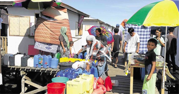 RESIDENTS of Barangay Mariki in Zamboanga City ready their containers for water rationing. JULIE S. ALIPALA
