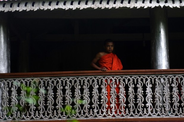A Buddhist monk stand at a temple which was destroyed during the riots in 2012, in Ramu some 350 kilometres (216 miles) southeast of the capital Dhaka on September 11, 2013.  Buddhist settlements in Ramu and Ukhia Upazila were vandalised and burned down in a fit of communal frenzy on September 29, 2012. These Buddhist villages and a total of 19 monasteries and temples that were heavily damaged have been rebuilt.   AFP PHOTO/Munir uz Zaman / AFP PHOTO / MUNIR UZ ZAMAN