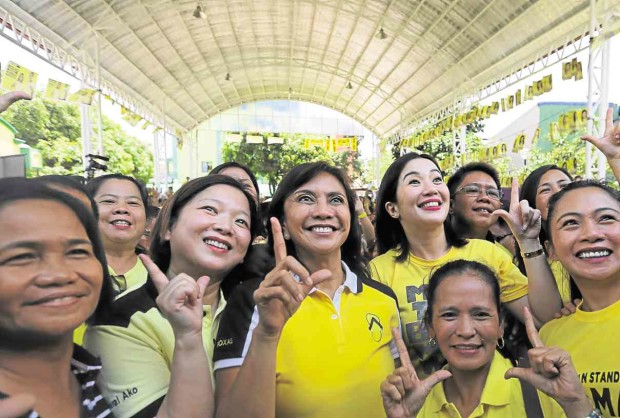 ALL THE SINGLE-MINDED LADIES  Liberal Party vice presidential contender Leni Robredo (center) shares a selfie with supporters during a campaign sortie at Old Balara, Quezon City, on Wednesday. Robredo is flanked by actress Harlene Bautista (left), and TV-movie star Kris Aquino. RAFFY LERMA 