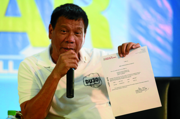 RODRIGO DUTERTE/ MAY 4,2016 Mayor Digong Duterte shows copies of his BPI pass book and bank statement in a pressconference held at the Phil Star in Manil;a. PHOTO/ JOAN BONDOC