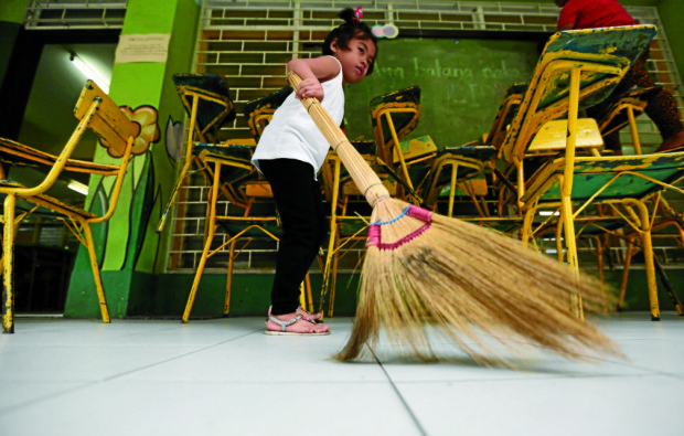 Blessie Fabricante, 5 years old, incoming grade 1 student, joins Brigada Eskwela and help clean a classroom in Kamuning Elementary School on Monday, May 30, 2016. INQUIRER PHOTO / GRIG C. MONTEGRANDE