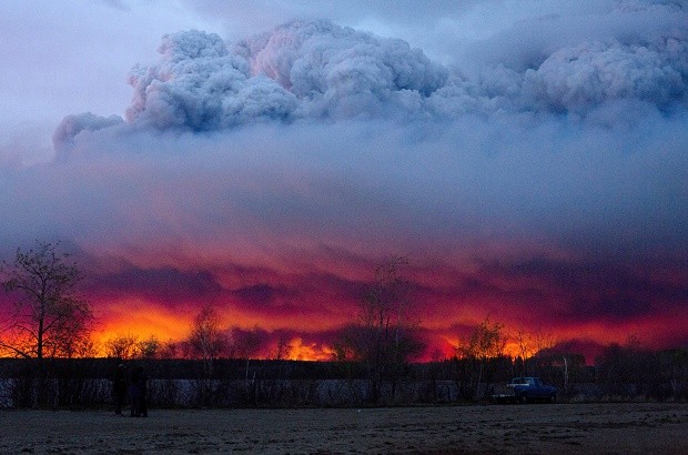 A wildfire moves towards the town of Anzac from Fort McMurray, Alberta., on Wednesday May 4, 2016. Alberta declared a state of emergency Wednesday as crews frantically held back wind-whipped wildfires. Unseasonably hot temperatures combined with dry conditions have transformed the boreal forest in much of Alberta into a tinder box.  JASON FRANSON/THE CANADIAN PRESS VIA AP