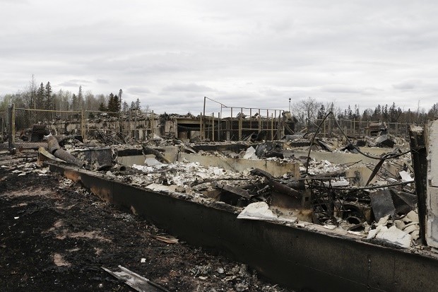 Destroyed townhouses in the Abasand neighborhood of Fort McMurray, Alberta, are viewed after a massive wildfire, Monday, May 9, 2016. A break in the weather has officials optimistic they have reached a turning point on getting a handle on the massive wildfire. AP