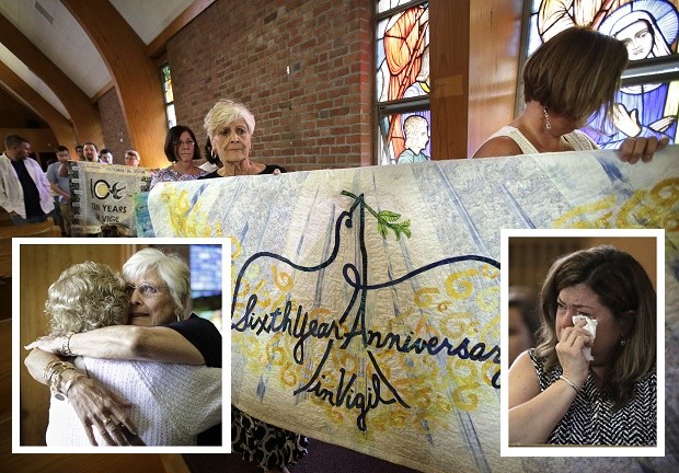 Parishioner Nancy Shilts, of Scitutate, Mass., center, and her daughter Karlyn Tropeano, of Abington, Mass., top right, join with others in carrying quilts made to mark the passing years of a vigil at the conclusion of a planned final service at St. Frances X. Cabrini Church, Sunday, May 29, 2016, in Scituate, Mass. For more than 11 years, a core group of about 100 die-hard parishioners at the church have kept their parish open by maintaining an around-the-clock vigil in protest of a decision by the Roman Catholic Archdiocese of Boston to close it following the clergy sex abuse crisis. On Sunday, the parishioners' efforts will end and they will vacate the Scituate church. (AP Photo/Steven Senne)