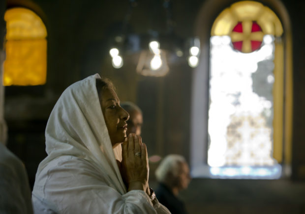 An Egyptian Coptic Christian prays during a service for the departed remembering the victims of EgyptAir flight 804, at Al-Boutrossiya Church, the main Coptic Cathedral complex in Cairo, Egypt, Sunday, May 22, 2016. The Airbus A320 plane was flying from Paris to Cairo with 66 passengers and crew when it disappeared early last Thursday over the Mediterranean Sea. (AP Photo/Amr Nabil)