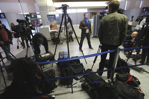 Reporters gather in front of the EgyptAir counter at Charles de Gaulle Airport outside of Paris, Thursday, May 19, 2016. An EgyptAir flight from Paris to Cairo carrying 66 people disappeared from radar early Thursday morning, the airline said. AP 