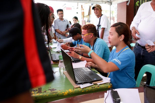 A woman attending to the needs of the voters. Photo by Tristan Tamayo/INQUIRER.net
