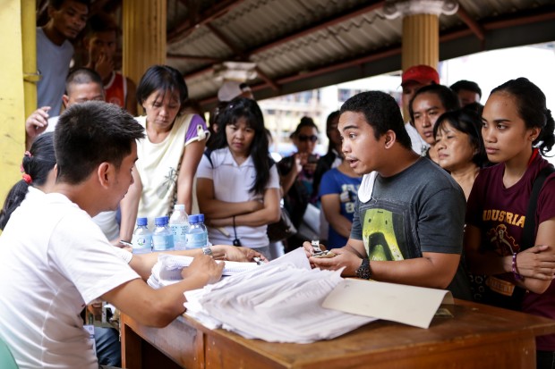 A man asks a Comelec official about his problems in voting at Batasan Hills National Highschool. Photo by Tristan Tamayo/INQUIRER.net