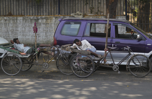 Indian rickshaw pullers rest under the shade of a tree on a hot summer day in Hyderabad, India, Wednesday, April 20, 2016. Weeks of sweltering temperatures have caused more than 160 deaths in southern and eastern India, officials said Tuesday, warning that any relief from monsoon rains was still likely weeks away. Most of the heat-wave victims were laborers and farmers in the states of Telangana, Andhra Pradesh and Orissa, though temperatures elsewhere in India have also hit 45 degrees Celsius (113 Fahrenheit).(AP Photo/Mahesh Kumar A.)