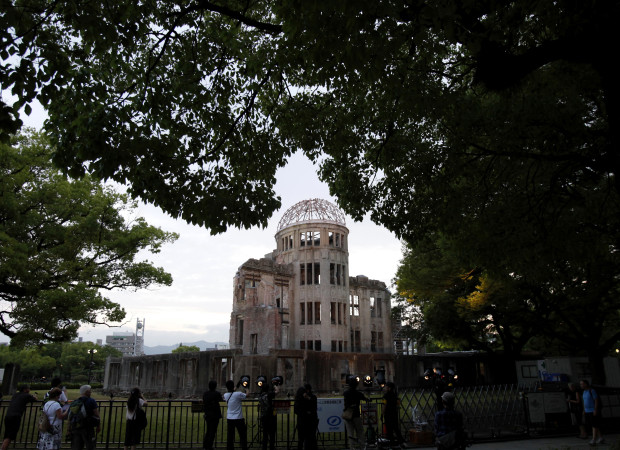 People gather around the gutted Atomic Bomb Dome at the Hiroshima Peace Memorial Park in Hiroshima, southwestern Japan, Thursday, May 26, 2016. President Barack Obama is to visit Hiroshima on Friday, May 27. Seven years ago, a new American president stood before cheering throngs in Prague’s historic Hradcany Square and laid out an audacious goal. “Today, I state clearly and with conviction America's commitment to seek the peace and security of a world without nuclear weapons,” Barack Obama declared. “I'm not naive. This goal will not be reached quickly _ perhaps not in my lifetime. It will take patience and persistence. But now we, too, must ignore the voices who tell us that the world cannot change. We have to insist, ‘Yes, we can.’”  (AP Photo/Shuji Kajiyama)