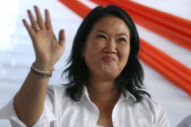 Presidential candidate Keiko Fujimori greets supporters as she campaigns in the San Juan de Lurigancho shantytown on the outskirts of Lima, Peru, Tuesday, May 10, 2016. The South American country is gearing up for a tight June 5th runoff between Keiko Fujimori, the daughter of jailed former President Alberto Fujimori, and former World Bank economist Pedro Kuczynski. (AP Photo/Martin Mejia)