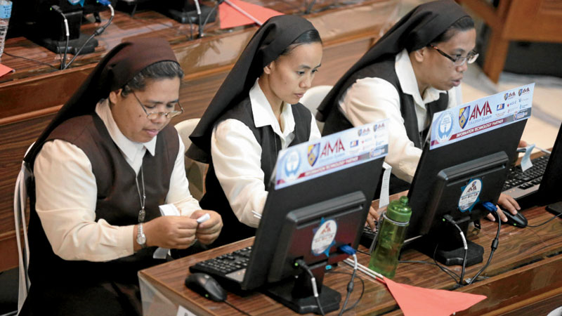 ENSURING FAIR COUNT Volunteer nuns monitor incoming election returns at the command center of the Parish Pastoral Council for Responsible Voting in Manila. GRIC C. MOTEGRANDE