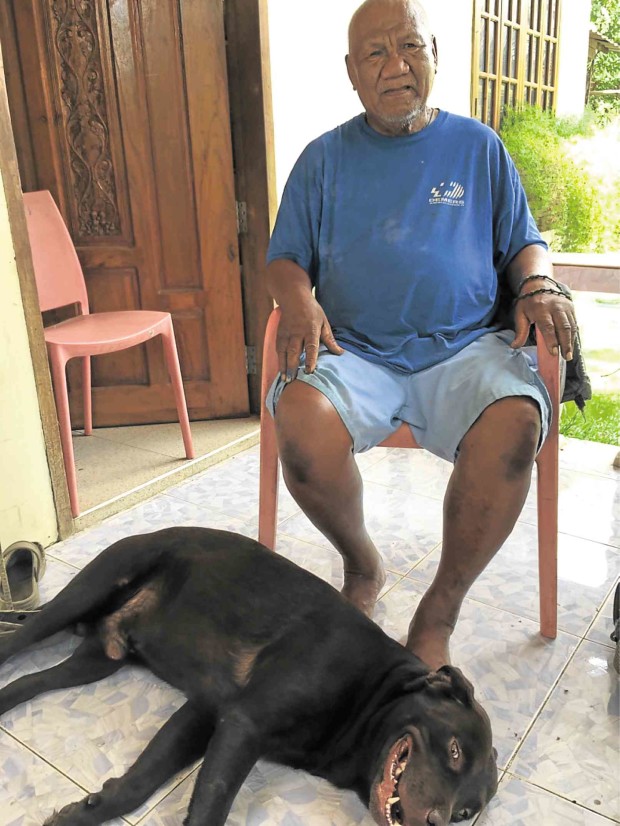 COUNCILOR Rodolfo Bayot at home with his constant companion, a chocolate labrador.    JULIE ALIPALA/INQUIRER MINDANAO