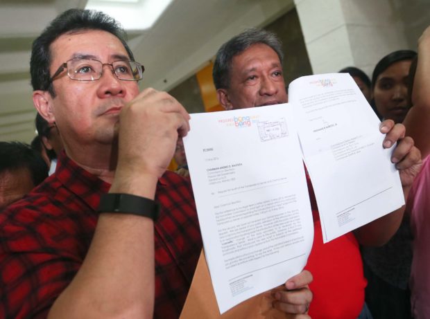 Atty. Jose Amor Amorado with Rep. Jonathan Dela Cruz at the COMELEC main office in Intramuros show copies of a formal demand from vice presidential candidate Sen. Ferdinand "Bongbong" Marcos Jr. for the COMELEC to conduct an audit of the automated election system. INQUIRER PHOTO/LYN RILLON