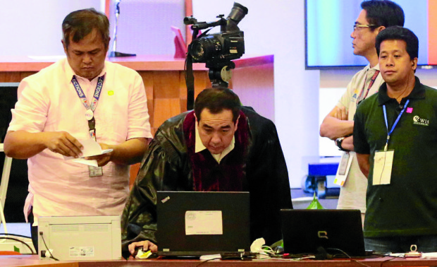 CANVASSING AT PICC Comelec Chair Andres Bautista enters his computer passcode for the canvassing of votes for the senatorial and party-list elections at the Philippine International Convention Center in Pasay City. GRIG C. MONTEGRANDE