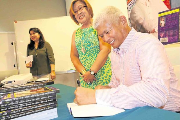 FORMER Immigration bureau chief Siegfred Mison autographs his new book as his former boss and “mentor”—former Justice Secretary and now Senator-elect Liela de Lima—looks on. Contributed photo