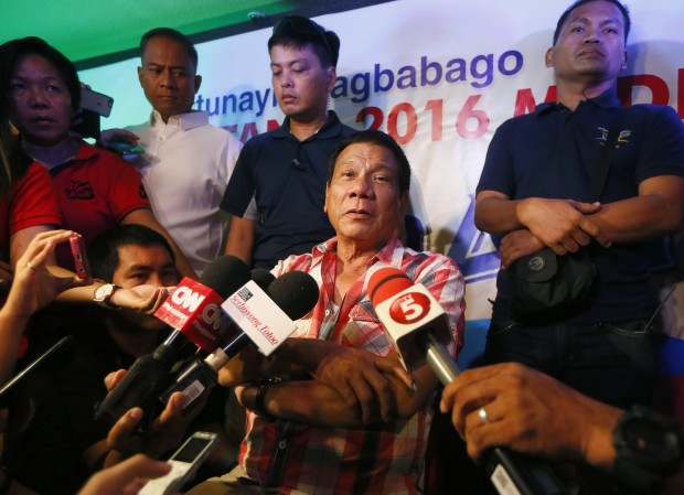 Front-running presidential candidate Mayor Rodrigo Duterte is interviewed by the media shortly after voting in a polling precinct at Daniel R. Aguinaldo National High School, Matina district, his hometown in Davao city in southern Philippines Monday, May 9, 2016. Duterte was the last to vote among five presidential hopefuls. (AP Photo/Bullit Marquez)