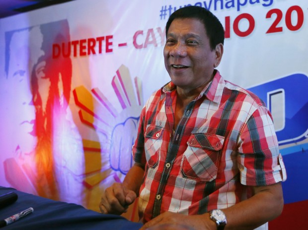 Front-running presidential candidate Mayor Rodrigo Duterte smiles during a news conference shortly after voting in a polling precinct at Daniel R. Aguinaldo National High School, Matina district, his hometown in Davao city, southern Philippines Monday, May 9, 2016. Duterte was the last to vote among five presidential hopefuls. (AP Photo/Bullit Marquez)