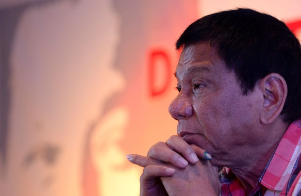 Presidential frontrunner and Davao City Mayor Rodrigo Duterte gestures during a press conference after he cast his vote in Davao City, on the southern island of Mindanao on May 9, 2016. Voting was underway in the Philippines on May 9 to elect a new president, with anti-establishment firebrand Rodrigo Duterte the shock favourite after an incendiary campaign in which he vowed to butcher criminals. / AFP PHOTO / NOEL CELIS