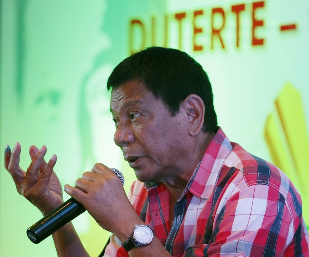 Front-running presidential candidate Mayor Rodrigo Duterte gestures during a news conference shortly after voting in a polling precinct at Daniel R. Aguinaldo National High School, Matina district, his hometown in Davao city in southern Philippines Monday, May 9, 2016. Duterte was the last to vote among five presidential hopefuls. AP