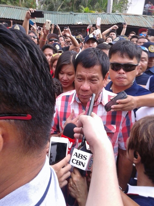 Presidential candidate Rodrigo Duterte makes his way to his polling precinct in Davao City to cast his vote here. NESTOR CORRALES/INQUIRER.net