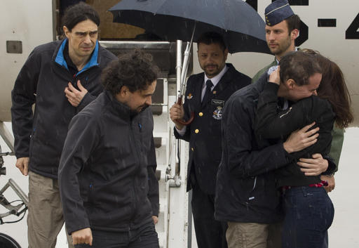In this photo made available by Presidencia del Gobierno on Sunday, May 8, 2016, the three freed Spanish journalists Antonio Pampliega, right, Jose Manuel Lopez, left, and Angel Sastre, arrive at the Torrejon military airbase in Madrid, Spain. Three Spanish journalists who went missing while working in Syria in July were freed from captivity, the Spanish government said on Saturday. Antonio Pampliega, Jose Manuel Lopez and Angel Sastre disappeared near the city of Aleppo in northern Syria on July 12. (Pool Moncloa via AP)