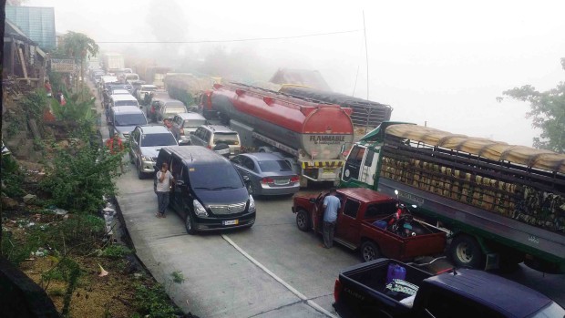 NO MOVEMENT Travelers get stuck in traffic for as long as 12 hours in Barangay Tactac in Santa Fe, Nueva Vizcaya province, due to a gridlock blamed on poor traffic management at many road repairs being carried out by the Department of Public Works and Highways.         CONTRIBUTED PHOTO