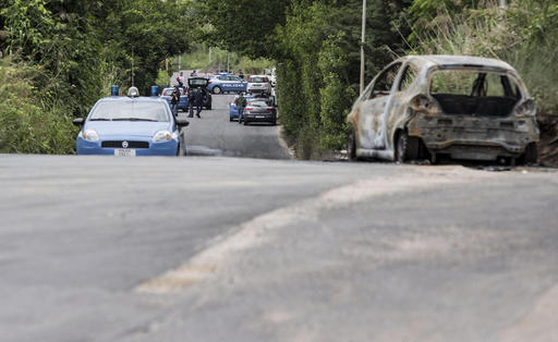 The burned car belonging to slain 22-year-old student Sara Di Pietrantonio is seen along a street in the outskirts of Rome, Monday, May 30, 2016. According to Italian police, Sara, who's body was found close to the car, has been burned alive by her ex-boyfriend as she was was trying to escape from him. (Massimo Percossi/ANSA via AP) ITALY OUT