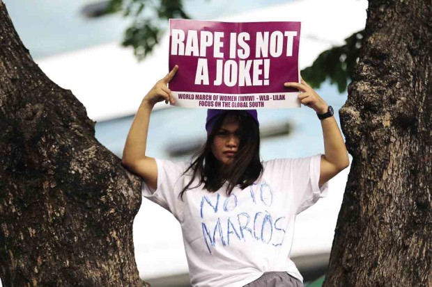 NO LAUGHING MATTER    A woman reminds motorists along Timog Avenue, Quezon City, of a serious  issue that presidential contender Rodrigo Duterte has treated as a joke.  Women’s groups dramatized their protest with a rally on Thursday.  RAFFY LERMA 
