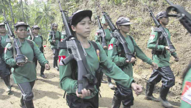 MARCHING INTO GOVERNMENT?  Armed guerrillas from the communist New People’s Army mark the rebel group’s founding anniversary in this file photo taken in 2009. Presumptive President-elect Rodrigo Duterte has said that he will offer Cabinet positions to some leaders of the communist group. DENNIS JAY SANTOS/INQUIRER MINDANAO