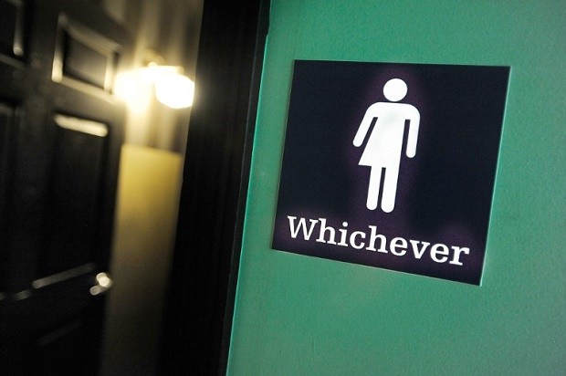 A gender neutral sign is posted outside a bathrooms at Oval Park Grill on May 11, 2016 in Durham, North Carolina. Debate over transgender bathroom access spreads nationwide as the US Department of Justice countersues North Carolina Governor Pat McCrory from enforcing the provisions of House Bill 2 (HB2) that dictate what bathrooms transgender individuals can use.   AFP