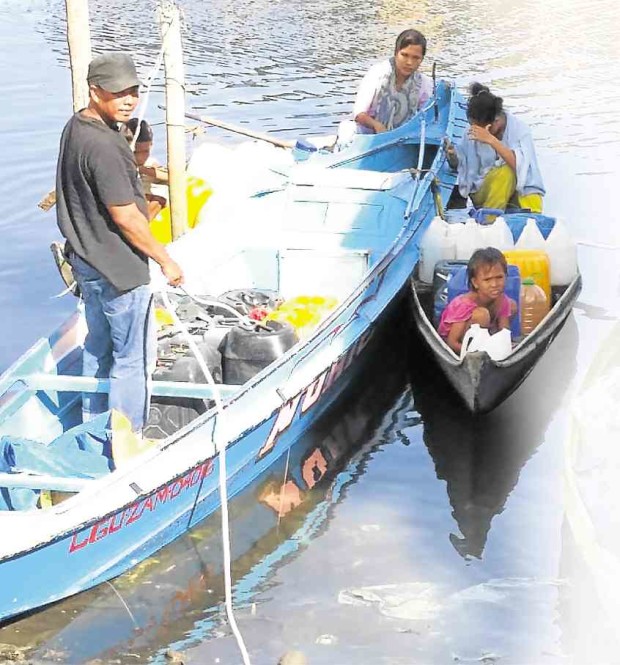 RESIDENTS of Zamboanga City load water containers  on their boats as the city continues to grapple with a shortage in potable water and water contamination.  