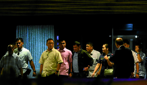 Surrounded with security personnel, President-elect Rodrigo Duterte leaves the Philippine International Convention Center in Pasay City after meeting his incoming cabinet members for the first time outside Davao City,INQUIRER PHOTO / RICHARD A. REYES