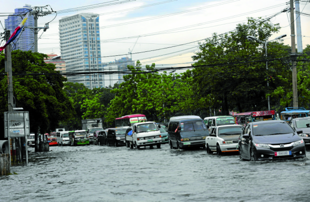 SUDDEN DOWNPOUR / JUNE 26, 2016 Motorists negotiate a flooded street in Manila on Sunday, June 26, 2016 after a sudden downpour. The weather bureau said an LPA off Eastern Samar has developed into a tropical depression and has been named Ambo turns 1st Philippine cyclone in 2016 and expected to make landfall in Aurora on Monday. INQUIRER PHOTO / GRIG C. MONTEGRANDE