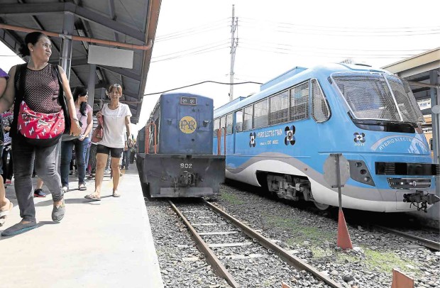 HI-TECH GOES LOCO. The DOST’s newly developed hybrid train easily outshines the old locomotives of the Philippine National Railways when formally unveiled on Saturday at PNR Tutuban station in Manila, with Science Secretary Mario Montejo among its first, proud passengers (inset, top). MARIANNE BERMUDEZ