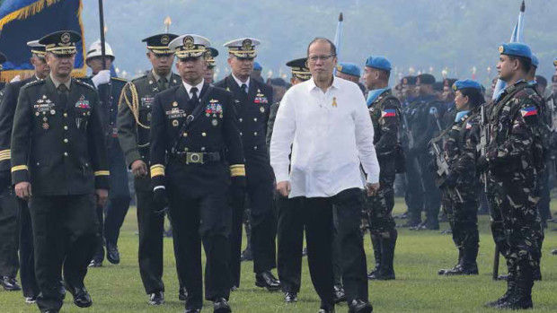 LAST PARADE President Aquino troops the line for the last time during the AFP testimonial parade and review held at Camp  Aguinaldo on Monday. JOAN BONDOC