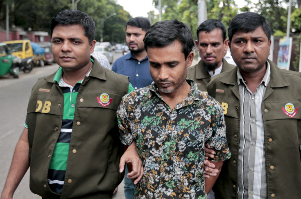 Members of Bangladesh Police Detective Branch (DB) escort a man, center, whom they have identified as Shariful Islam Shihab, a former member of the banned Islamic group Harkatul Jihad as they walk him in front of the media in Dhaka, Bangladesh, Sunday, May 15, 2016. Police said Sunday that they have arrested Shihab, a suspected Muslim militant for his alleged involvement in the killing last month of a gay rights activist and his friend in the capital. (AP Photo)