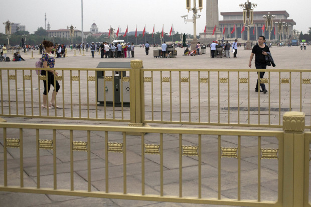 Visitors walk across Tiananmen Square in Beijing, Saturday, June 4, 2016. Saturday marks the 27th anniversary of Chinas bloody crackdown on pro-democracy protests centered on Beijings Tiananmen Square. (AP Photo/Mark Schiefelbein)