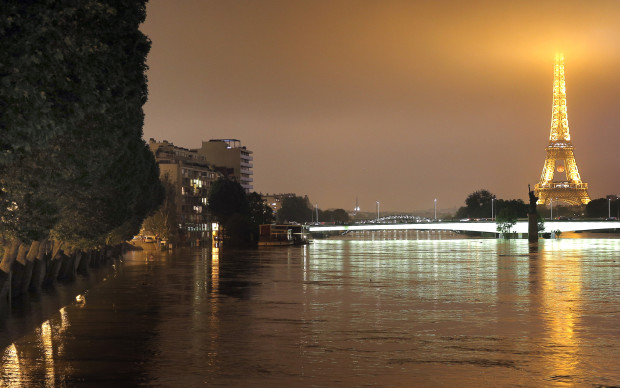 View of the flooded banks of the river Seine in front of the Eiffel tower in Paris, Friday, June 3, 2016. Both the Louvre and Orsay museums were closed as the Seine, which officials said was at its highest level in nearly 35 years, was expected to peak sometime later Friday. (AP Photo/Christophe Ena)