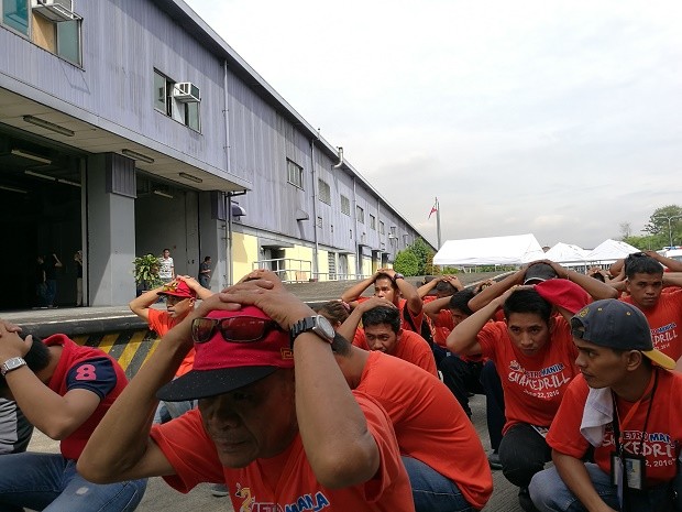 Metro Manila Shake Drill volunteers performed the “duck, cover, hold” technique shortly after the drills commenced at 9 a.m. outside the LRT2 train depot in Santolan, Pasig. CHRISTIAN VENUS/Inquirer Volunteer