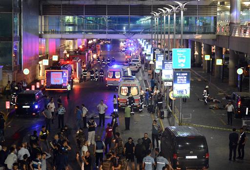 Medics and security members work at the entrance of the Ataturk Airport after explosions in Istanbul, Tuesday, June 28, 2016. Two explosions have rocked Istanbul's Ataturk airport, killing several people and wounding others, Turkey's justice minister and another official said Tuesday.