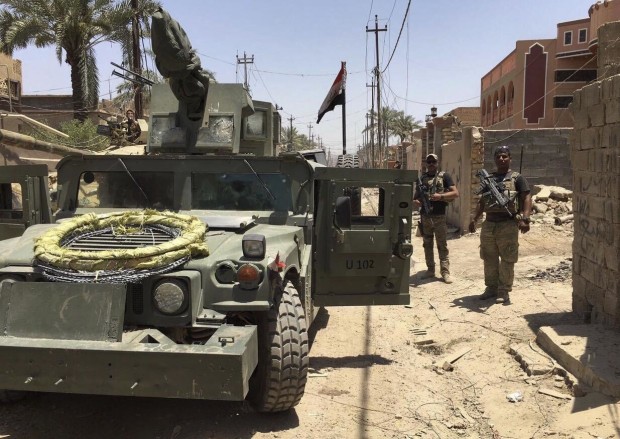 Iraqi security forces enter the al-Julan neighborhood after defeating Islamic State militants in Fallujah, Iraq, Sunday, June 26, 2016. A senior Iraqi commander said the city of Fallujah was "fully liberated" from Islamic State militants on Sunday, after a more than monthlong military operation.  (AP Photo)