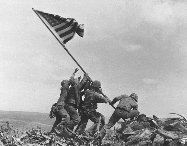 In this Feb 23, 1945 file photo, U.S. Marines of the 28th Regiment, 5th Division, raise the American flag atop Mt. Suribachi, Iwo Jima, Japan. The Marines Corps announced Thursday, June 23, 2016, that one of the six men long identified in the iconic World War II photograph was actually not in the image. A panel found that Private First Class Harold Schultz, of Detroit, was in the photo and that Navy Pharmacist's Mate 2nd Class John Bradley wasn't in the image. Bradley had participated in an earlier flag-raising on Mount Suribachi. AP FILE PHOTO