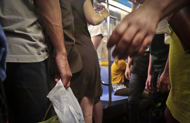 Subway riders board a train during rush hour, Wednesday, June 22, 2016, in New York. As subway ridership reaches an all-time record, police say reports of sex offenses underground are also on the rise, up nearly 57 percent from last year. (AP Photo/Bebeto Matthews)